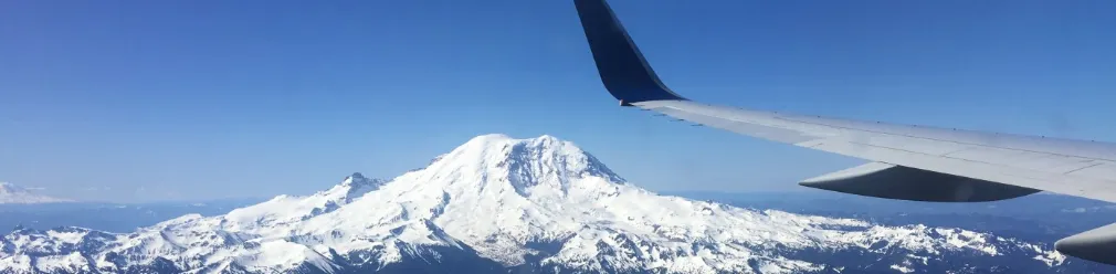 Mount Rainier from an airplane window, with the wing in the foreground